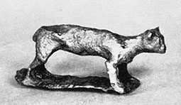 Bronze figurine of four-legged animal, which appears very cat-like but probably represents a dog